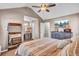 Beautiful main bedroom featuring vaulted ceilings, hardwood floors, and a TV over a rustic dresser at 3360 Pinewood Dr, Ladson, SC 29456