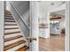 View of staircase and living room with hardwood floors and open floorplan at 3360 Pinewood Dr, Ladson, SC 29456