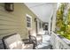 Charming back porch with wicker furniture and a view of the garden at 36 Bogard St, Charleston, SC 29403