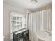 Bathroom with cabinet, curtain, and a window with natural light at 36 Bogard St, Charleston, SC 29403