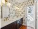 Bathroom featuring a double sink vanity and fern wallpaper at 36 Bogard St, Charleston, SC 29403