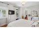 Bright bedroom features a TV, ensuite bathroom, and view to the exterior at 36 Bogard St, Charleston, SC 29403