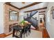 Dining area with a brick accent wall, hardwood floors, and a view of the staircase at 36 Bogard St, Charleston, SC 29403
