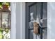 A dark-colored front door with a pineapple knocker and traditional lantern at 36 Bogard St, Charleston, SC 29403
