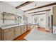 Bright kitchen featuring marble countertops, stainless appliances, wooden beams, and an eat-in nook with an abundance of natural light at 36 Bogard St, Charleston, SC 29403