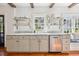 Bright kitchen featuring marble countertops, stainless appliances, open shelves, and an eat-in nook with an abundance of natural light at 36 Bogard St, Charleston, SC 29403