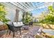 Charming brick patio beneath a pergola, surrounded by lush greenery, perfect for outdoor relaxation and entertaining at 36 Bogard St, Charleston, SC 29403