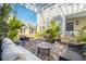 Beautiful outdoor patio featuring brick flooring, cozy seating under a bright pergola, and tropical plants at 36 Bogard St, Charleston, SC 29403