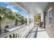 Outdoor porch with white pillars, a wicker chair, and views of the community at 36 Bogard St, Charleston, SC 29403
