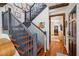 Elegant staircase with dark railings, hardwood steps, and rustic walls at 36 Bogard St, Charleston, SC 29403