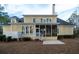 Charming yellow home featuring a screened-in porch, patio, and lush backyard at 3711 Riverstation Ct, Mount Pleasant, SC 29466
