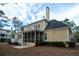 Charming yellow home featuring a screened-in porch, patio, and lush backyard at 3711 Riverstation Ct, Mount Pleasant, SC 29466