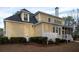 Charming yellow home featuring an open porch and well-manicured lawn at 3711 Riverstation Ct, Mount Pleasant, SC 29466