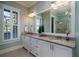 Well-appointed bathroom with dual sinks, granite countertops, and a glass-enclosed shower at 3711 Riverstation Ct, Mount Pleasant, SC 29466