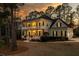 Inviting two-story yellow home with a spacious porch surrounded by mature trees at 3711 Riverstation Ct, Mount Pleasant, SC 29466