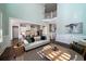 Sunlit living room showcasing an open layout with a view of the modern kitchen and staircase at 3711 Riverstation Ct, Mount Pleasant, SC 29466