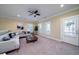 Cozy living room featuring a ceiling fan, natural light, and a comfortable sectional sofa at 3711 Riverstation Ct, Mount Pleasant, SC 29466