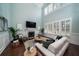 Open living room with high ceilings, fireplace, large windows, and modern furnishings with elegant decor at 3711 Riverstation Ct, Mount Pleasant, SC 29466