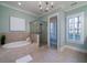 Luxury main bathroom features a soaking tub, glass-enclosed shower, and classic finishes at 3711 Riverstation Ct, Mount Pleasant, SC 29466