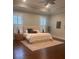 Spacious main bedroom with tray ceilings, hardwood floors, and plantation shutters at 3711 Riverstation Ct, Mount Pleasant, SC 29466