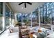 Inviting screened porch with comfortable seating, ceiling fan, and a view of the wooded backyard at 3711 Riverstation Ct, Mount Pleasant, SC 29466