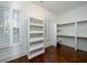 Bright walk-in closet with built-in shelves, ample storage, and natural light from shuttered windows at 3711 Riverstation Ct, Mount Pleasant, SC 29466