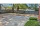 A large, fenced backyard featuring a concrete patio and mature trees offers privacy at 409 Dowling Ave, Walterboro, SC 29488
