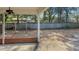 Covered patio overlooking shady back yard surrounded by a wooden fence at 409 Dowling Ave, Walterboro, SC 29488