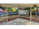 Covered back patio with ceiling fans overlooking the shady back yard and detached shed at 409 Dowling Ave, Walterboro, SC 29488