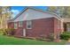 Exterior side view of brick home showing brick detail and small brick-lined garden at 409 Dowling Ave, Walterboro, SC 29488