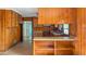 Open kitchen with wood paneling, a breakfast bar, and plenty of natural light at 409 Dowling Ave, Walterboro, SC 29488