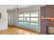 Bright living room with a red brick fireplace, hardwood floors, and large window at 409 Dowling Ave, Walterboro, SC 29488