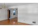 Open living space with hardwood floors, a chandelier, and an open doorway to another room at 409 Dowling Ave, Walterboro, SC 29488