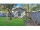 Outdoor storage shed with treed back yard and wooden fence at 409 Dowling Ave, Walterboro, SC 29488