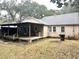 Exterior view of home featuring back porch and a spacious backyard with mature trees at 411 Maplewood Dr, Walterboro, SC 29488