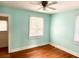 Inviting bedroom with hardwood floors, soft turquoise walls, and a ceiling fan at 411 Maplewood Dr, Walterboro, SC 29488