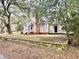 Exterior view of home with brick chimney and mature trees at 411 Maplewood Dr, Walterboro, SC 29488