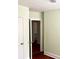 Interior hallway with hardwood floors and neutral paint, connecting to additional rooms at 411 Maplewood Dr, Walterboro, SC 29488