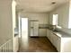 Well-lit kitchen features ample white cabinets, modern appliances, and durable flooring at 411 Maplewood Dr, Walterboro, SC 29488
