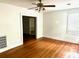 Spacious living room with hardwood flooring, natural light, and a view into another room at 411 Maplewood Dr, Walterboro, SC 29488
