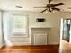 Bright living room with hardwood floors, a decorative fireplace, ceiling fan, and natural light at 411 Maplewood Dr, Walterboro, SC 29488