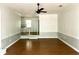 Inviting living room showcasing hardwood floors, wainscoting detail, and a ceiling fan fixture at 411 Maplewood Dr, Walterboro, SC 29488