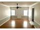 Bright living room with hardwood floors, wainscoting, and ample natural light from multiple windows at 411 Maplewood Dr, Walterboro, SC 29488