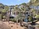 Stately two-story home with covered porch, surrounded by palm trees and manicured landscaping at 4983 Sound View Dr, Mount Pleasant, SC 29466