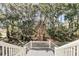 Beautiful backyard and forest view from a house deck with white wooden railings at 4983 Sound View Dr, Mount Pleasant, SC 29466