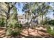 Beautiful backyard with mature trees and landscaping and screened porch at 4983 Sound View Dr, Mount Pleasant, SC 29466