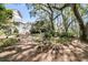 Expansive backyard featuring lush landscaping, mature trees, and a charming home exterior with stairs at 4983 Sound View Dr, Mount Pleasant, SC 29466