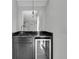 Stylish bar area featuring a dark counter, built-in cooler, glass shelves, and pendant lighting at 4983 Sound View Dr, Mount Pleasant, SC 29466