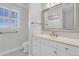 Bright bathroom with a large vanity, white cabinets, marble countertops, and a big framed mirror above the sink at 4983 Sound View Dr, Mount Pleasant, SC 29466