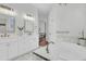 Bright bathroom featuring double vanities, soaking tub, tile flooring, and modern fixtures at 4983 Sound View Dr, Mount Pleasant, SC 29466